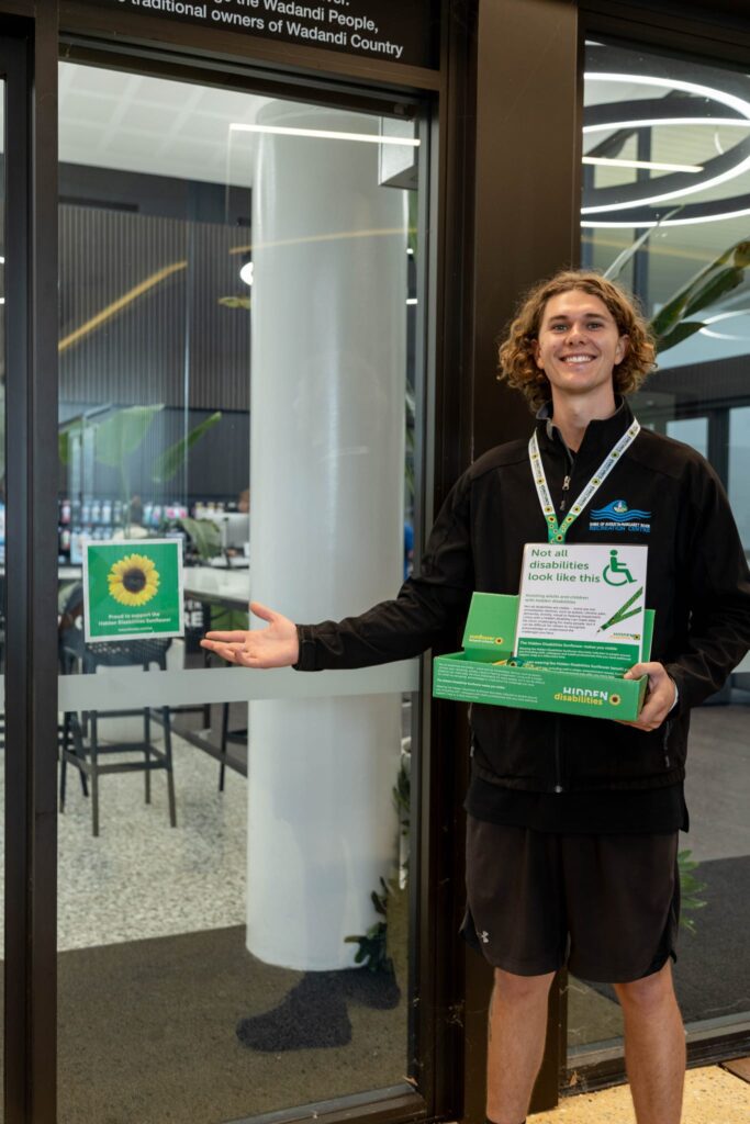 A Margaret River Recreation Centre member of staff introducing the Hidden Disabilities Sunflower Initiative