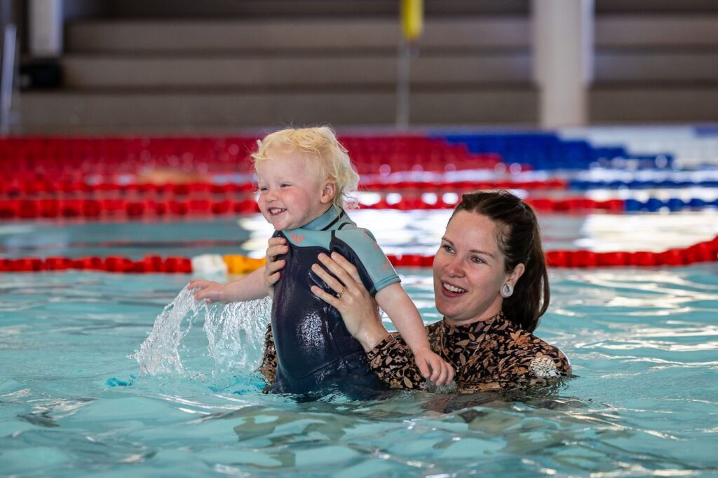 A mother and young child participating in a Margaret River Swim School lesson.