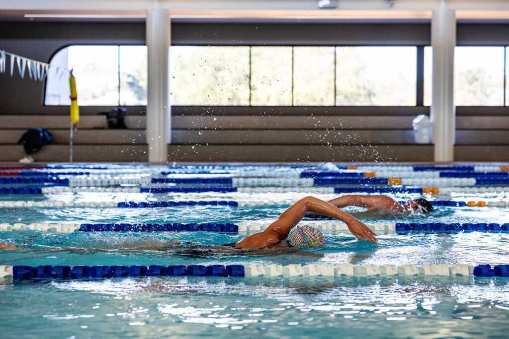 Two swimmers in a pool doing laps in separate lanes at Margaret River Recreation Centre.