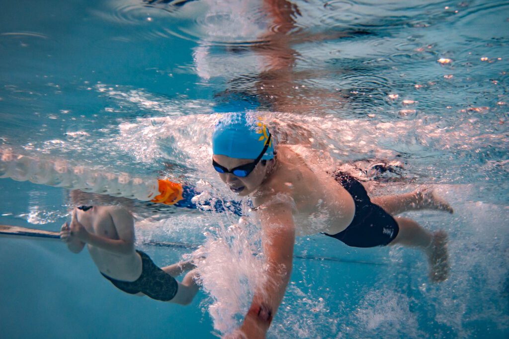 A child swimming laps underwater.