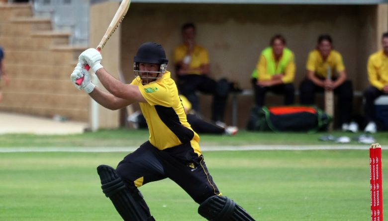A cricketer swinging a bat.